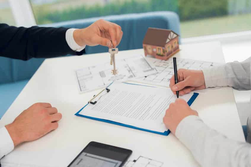 conclusion of a contract for purchase of draft with realtor. close up photo of contract and draft.